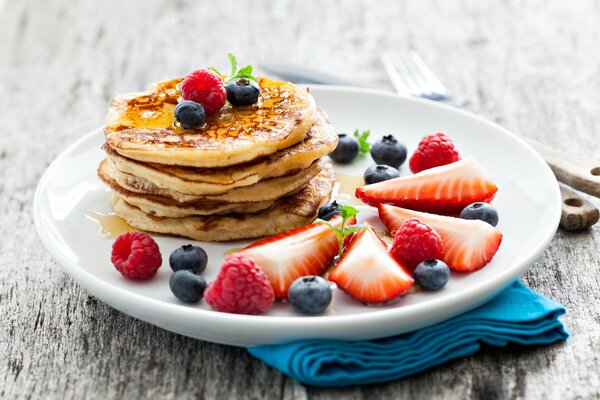 Delicious pancakes with berries on a plate