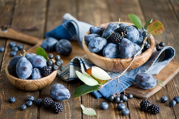 Still life with plums and autumn berries