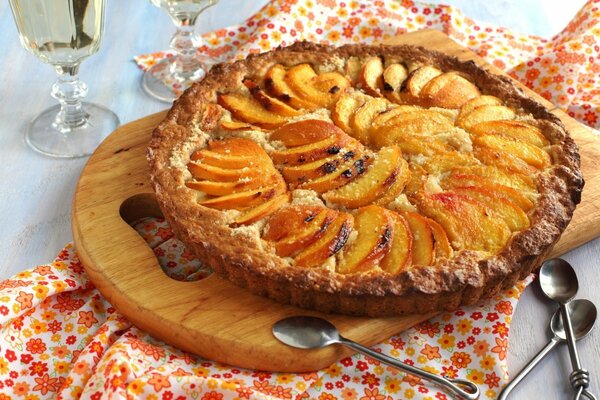 Peach pie on a wooden board