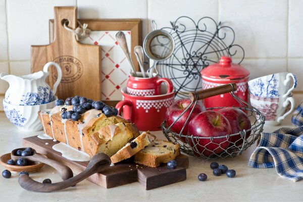 Still life of a cupcake with yanods and apples