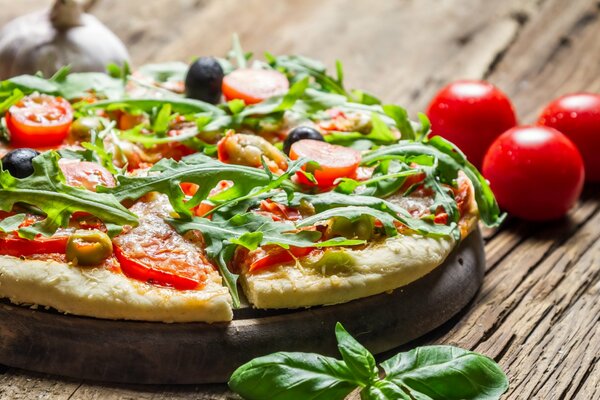 Homemade pizza with tomatoes and olives