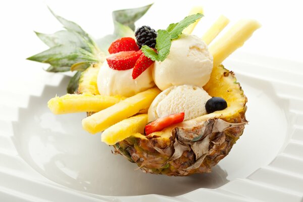 Ice cream balls with berries in pineapple