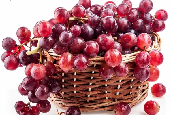 A bunch of red grapes in a basket
