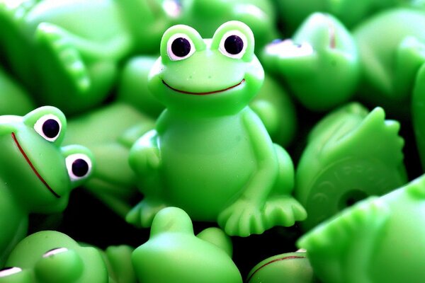 Background with green rubber frogs