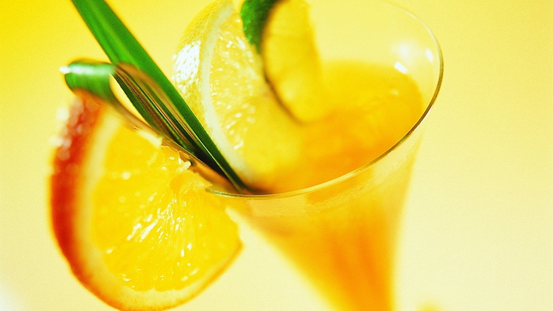 cocktail yellow close up orange lemon lima segments glass drink leaf