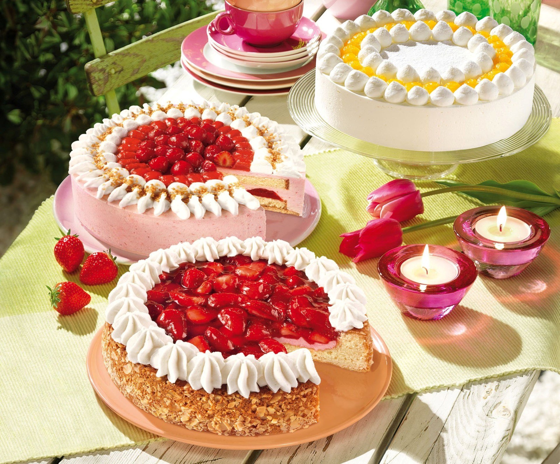 cakes strawberries cream cream nuts holiday table tulips serving candle