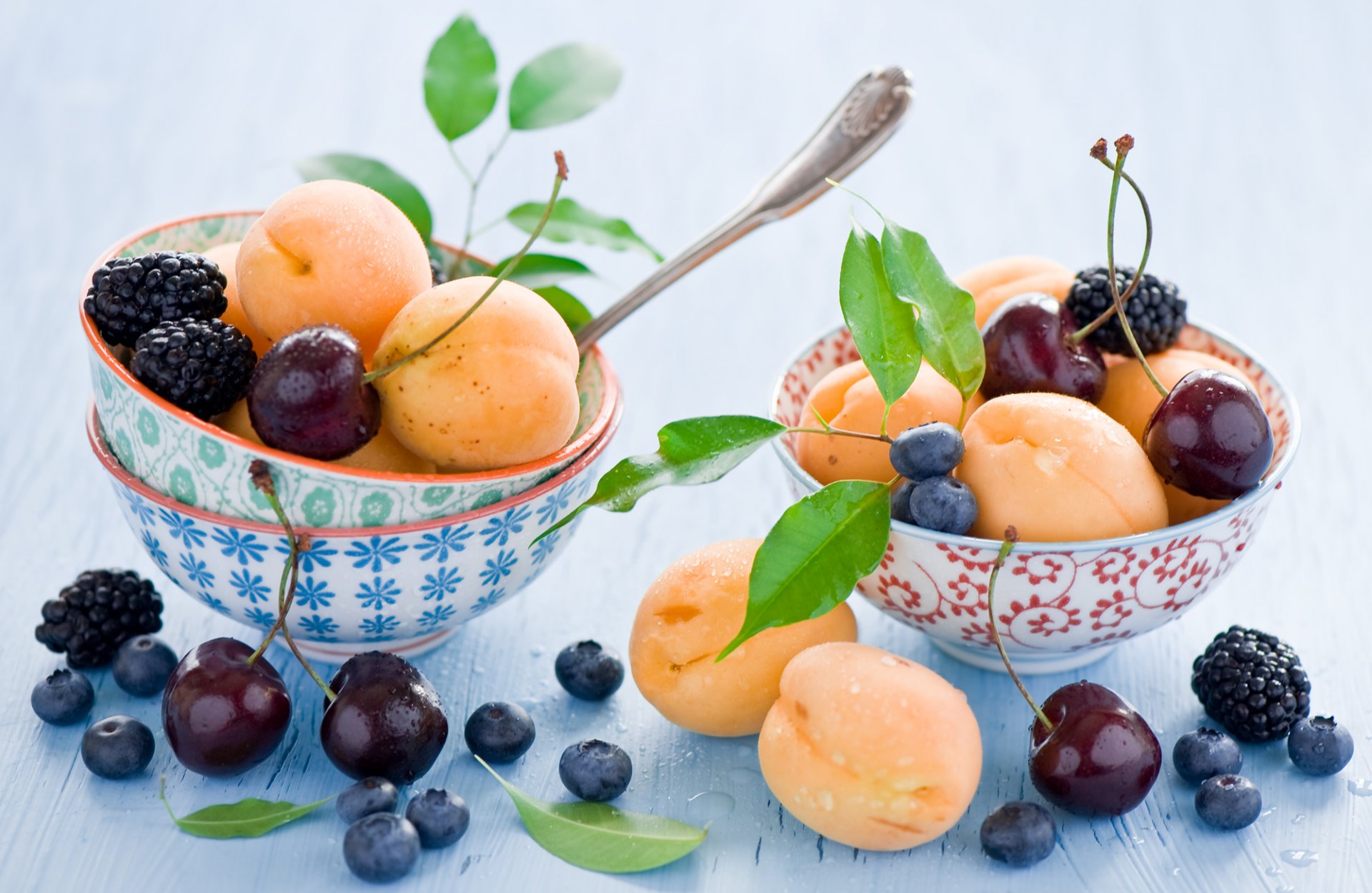 apricots cherries blueberries blackberries blueberries fruits berries leaves dishes bowls spoons still life anna verdina