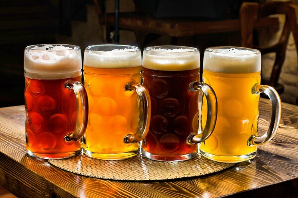 Four mugs of different beers