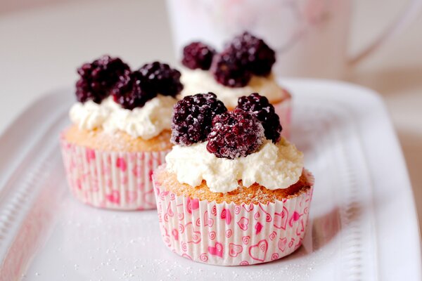 Delicious cream cupcakes with berries