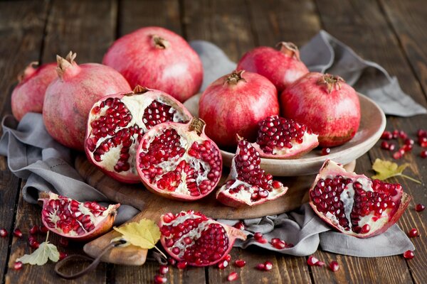 Ripe pomegranates on the table in autumn