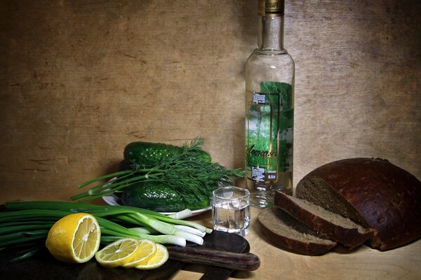 Still life: bread, vodka, lemon, onion, cucumbers