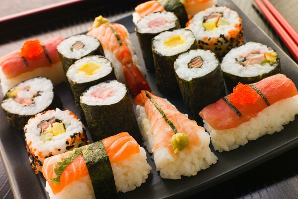 A set of different sushi with chopsticks