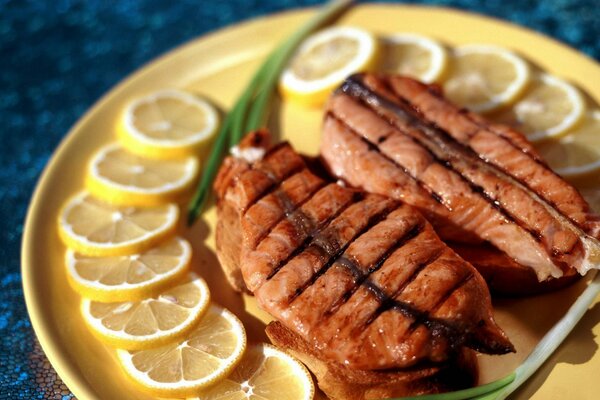 Meat steak with lemon on a plate