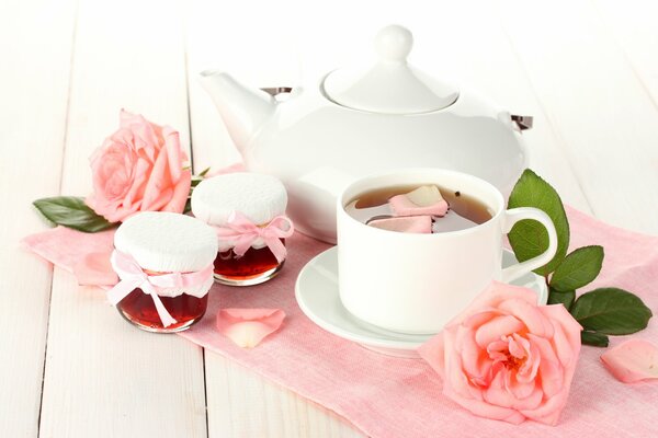 Delicious hour in a white cup on a saucer with rose petals