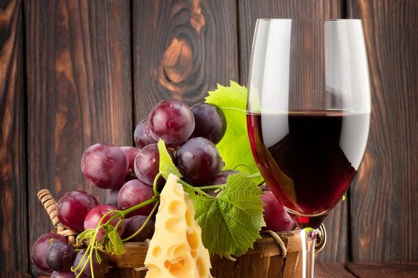 Glas Rotwein mit Käse und Trauben