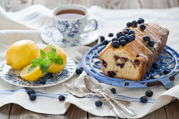 Sweet cupcake with blueberries for dessert and a plate with lemon