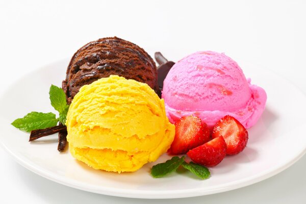 Assorted ice cream balls with strawberries for dessert