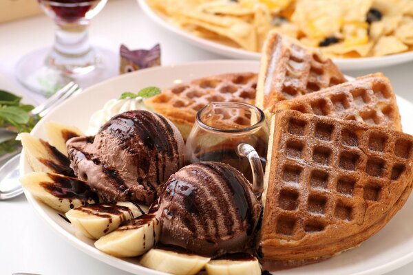 Delicious waffles with banana and chocolate ice cream