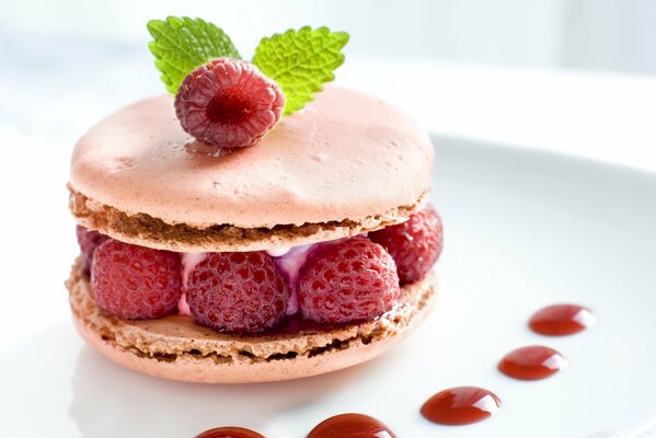 Pink macaroon cookies with red raspberries