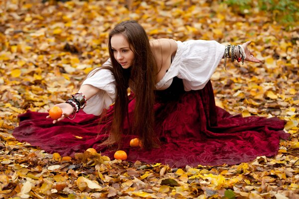 Autumn has come and the girl is picking tangerines