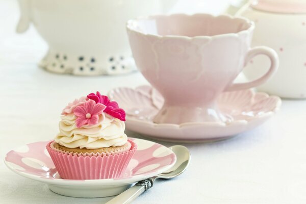 Cupcake with cream decorated with pink flowers