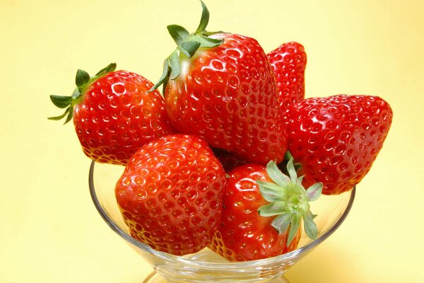 Ripe strawberries in a transparent cup