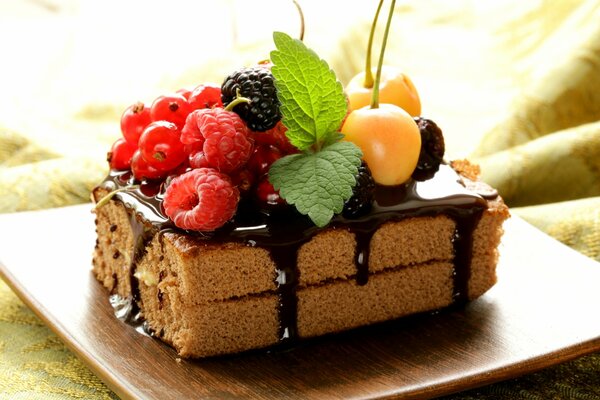 Photo of a chocolate-coated cake with berries