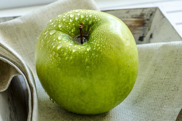 Water droplets on a green apple