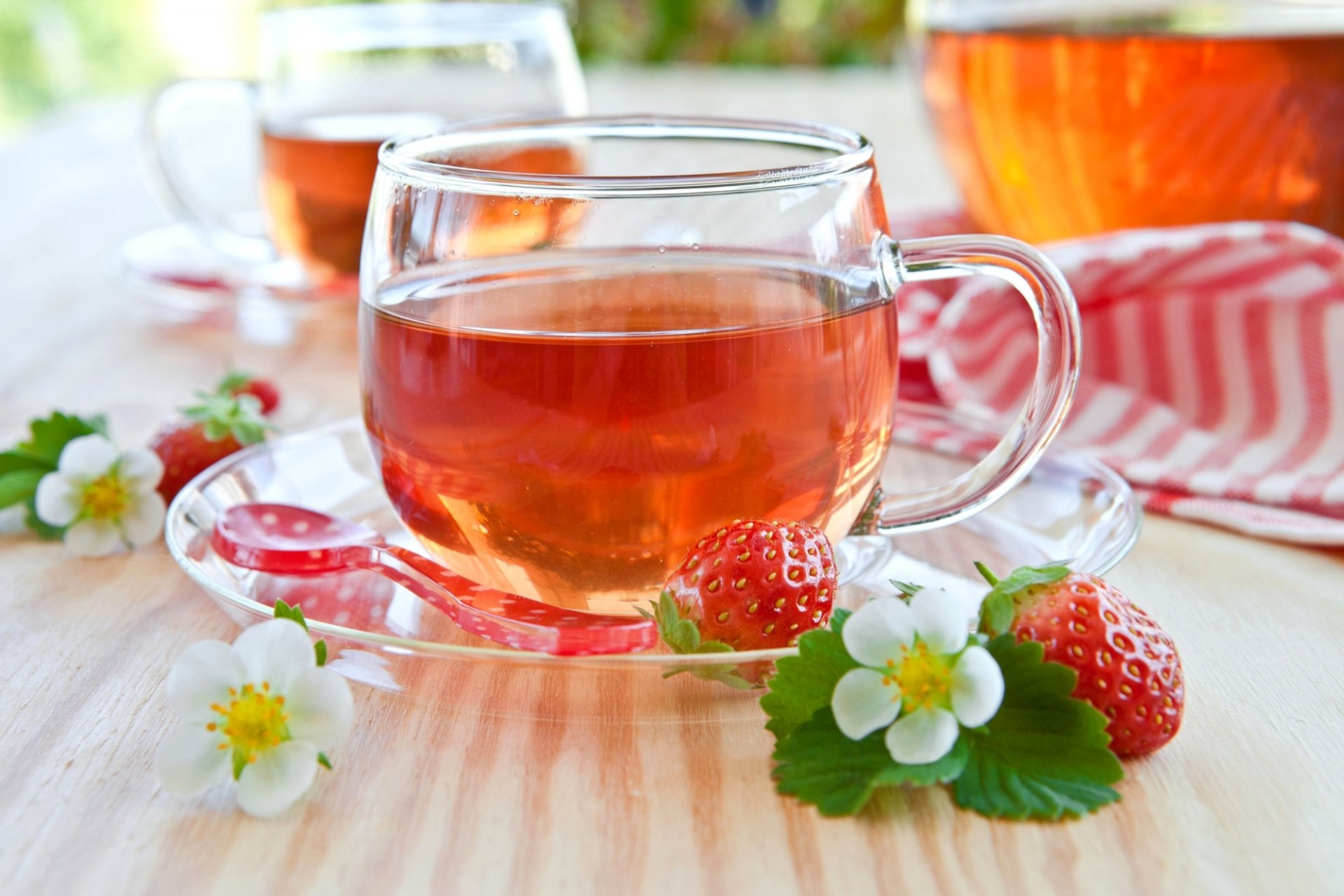 tea cup saucer dishes spoon strawberries strawberries berries red leaves flowers white table