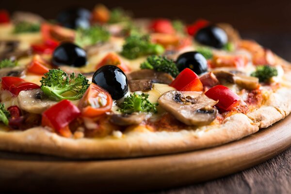 Pizza with mushrooms olives tomatoes and parsley