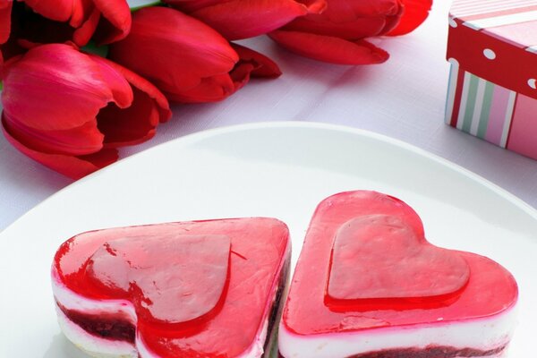 Dessert in the form of a heart and red tulips