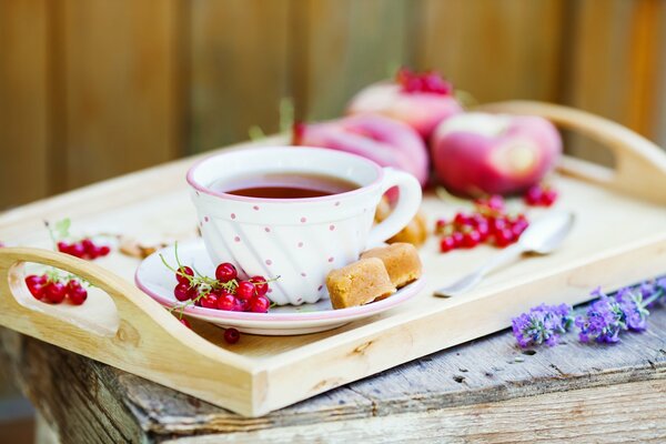 Sweet tea with pastries on a wooden tray