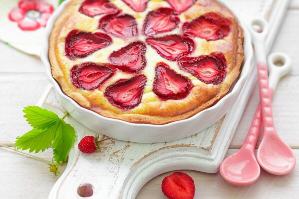 Käsekuchen mit Erdbeeren auf weißem Hintergrund