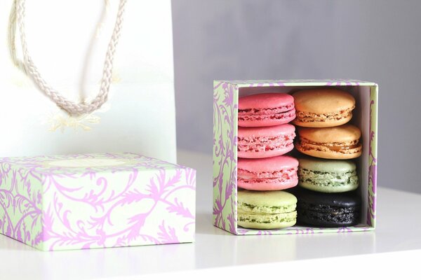 Macaron cookies in a multi-colored box