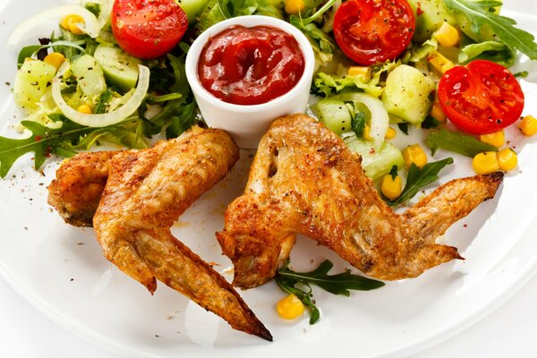 Dish chicken wings with vegetable salad