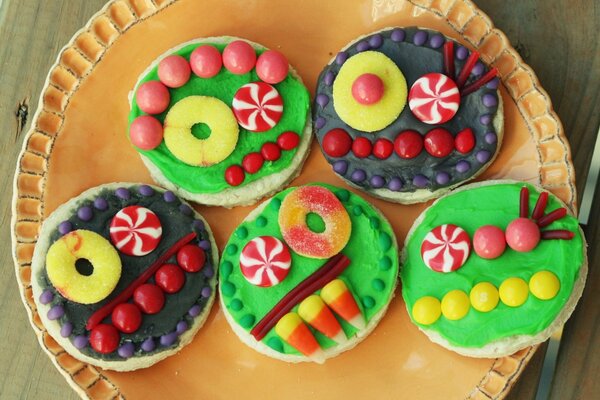 Colorful cookie emoticons on a yellow platter