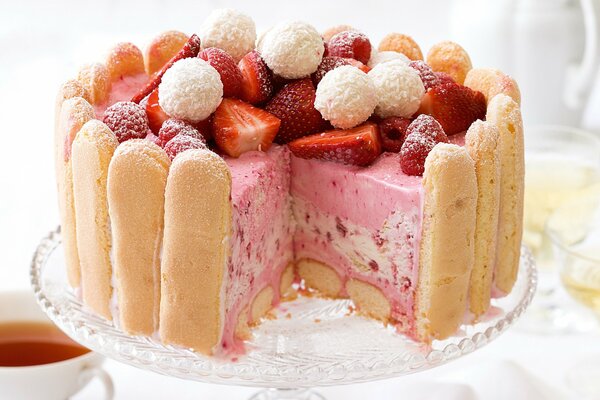 Delicious cake with tea and strawberries