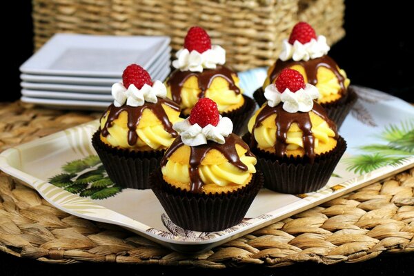 Muffins in Zuckerguss mit Himbeeren und Sahne