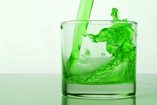 Transparent glass with green drink
