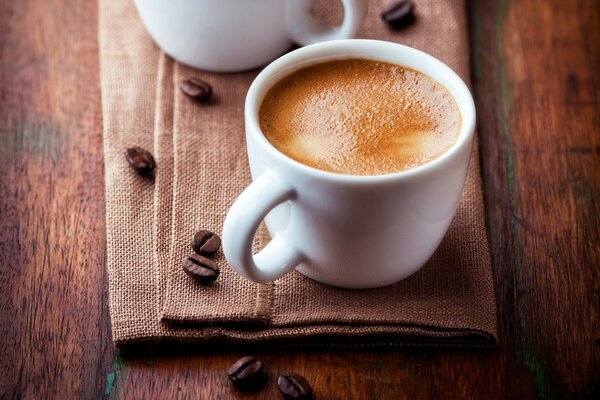 A cup of coffee with coffee beans