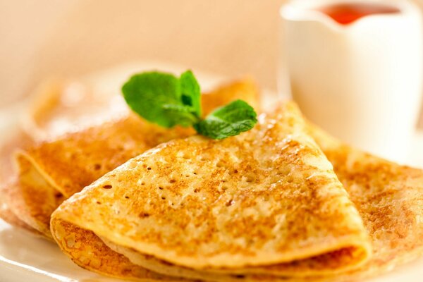 Morning breakfast with pancakes decorated with mint leaf