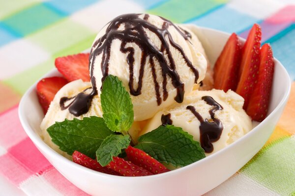 Ice cream poured with chocolate with fresh berries