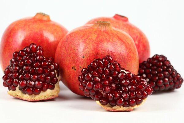 Juicy, red pomegranate whole and sliced