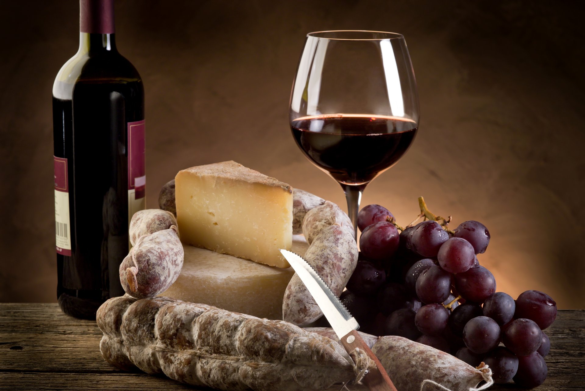 wine red cheese parmesan sausage grapes glass a bottle knife