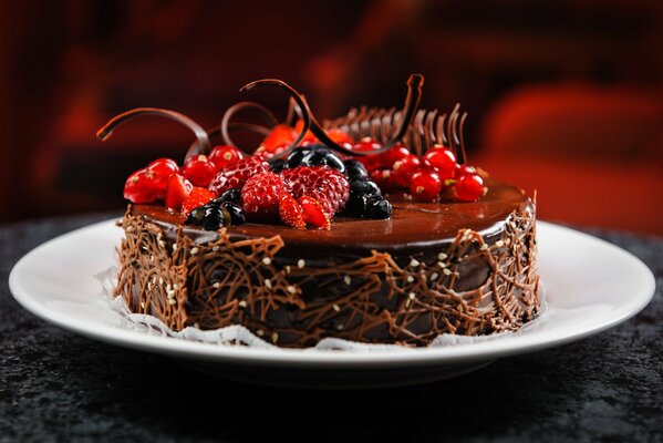 Cake on a white plate with raspberries