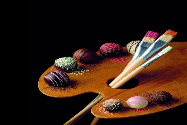 Decoration of sweets on a board with brushes