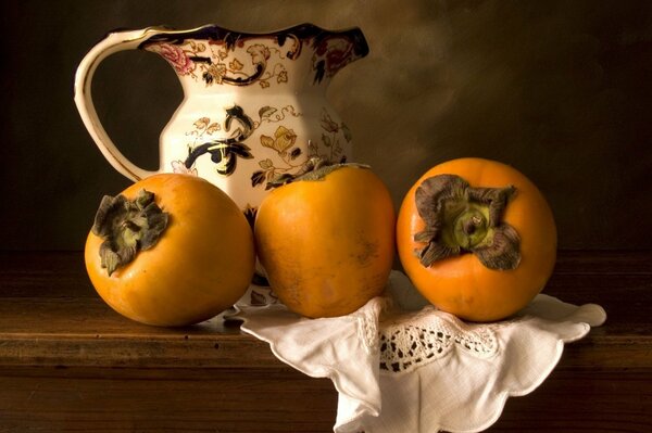 Three persimmons near an ancient jug