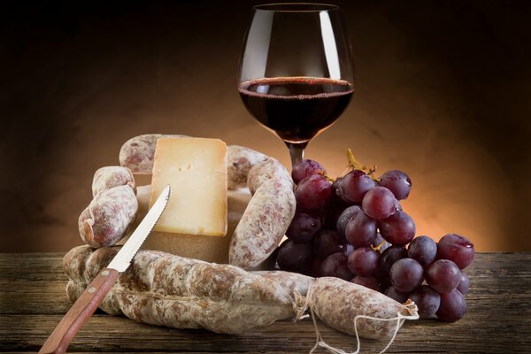 Image of red wine, grapes, cheese and salami