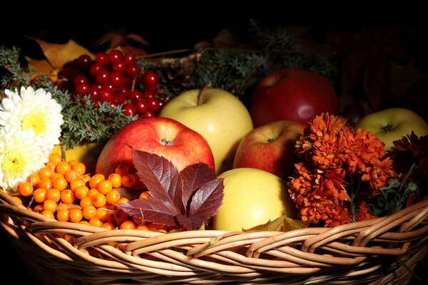 Still life of apples , berries and flowers in a basket