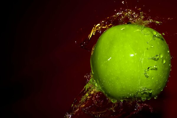 Green juicy apple in a splash of water